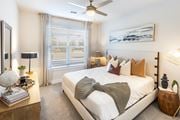 North Charleston apartment for rent - a bedroom with a large bed and a ceiling fan