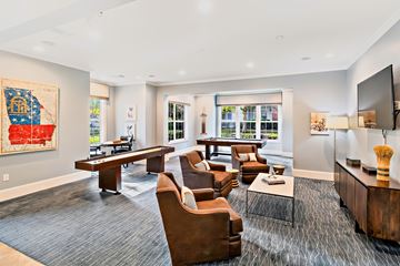 Suwanee apartment for rent - A living room with a grey carpet and brown leather chairs.