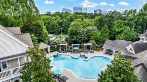 Atlanta apartment for rent - A swimming pool surrounded by trees and houses.