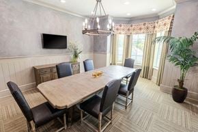 Duluth apartment for rent - a dining room with a wooden table and chairs and a television