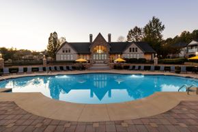 Duluth apartment for rent - a swimming pool with a house in the background at The Reserve at Sugarloaf Apartments, Duluth, GA, 30097