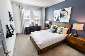 Lawrenceville apartment for rent - a bedroom with a bed and two windows