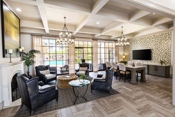 Duluth apartment for rent - a living room with a fireplace and a table with chairs