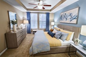 Duluth apartment for rent - A bedroom with a bed, nightstands, and a ceiling fan.