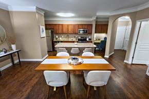 Duluth apartment for rent - A kitchen with a table and chairs in the foreground.