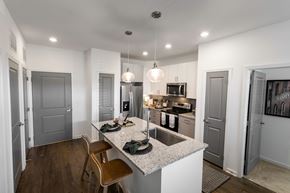 Nashville apartment for rent - a kitchen with a center island with a sink and two stools
