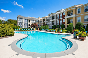 Alpharetta townhouse for rent - A swimming pool in front of apartment buildings.