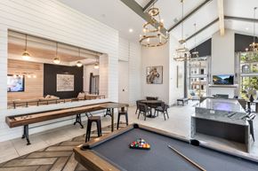 Grayson apartment for rent - A pool table is in the middle of a room with a bar and a television.
