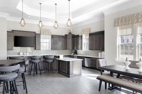 Apex apartment for rent - an open concept kitchen and dining area with a large table and chairs