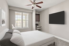 Apex apartment for rent - a bedroom with a bed and a ceiling fan