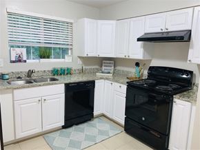 Atlanta apartment for rent - a kitchen with black appliances and white cabinets