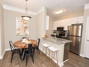 Alpharetta apartment for rent - A kitchen with a table and chairs in the middle of the room.