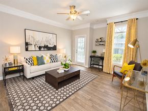 Alpharetta apartment for rent - A living room with a white couch, a coffee table, and a painting on the wall.