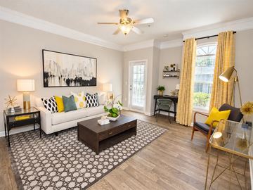 Alpharetta apartment for rent - A living room with a white couch, a coffee table, and a painting on the wall.
