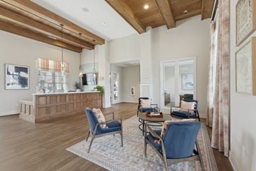 Cartersville apartment for rent - A living room with a blue chair and a brown cabinet.