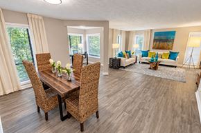 Alpharetta apartment for rent - A dining room with a wooden table and chairs.