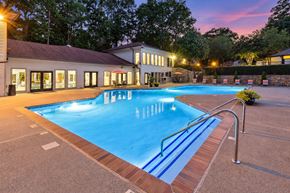Alpharetta apartment for rent - A large swimming pool with a building in the background.