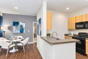 Fort Mill apartment for rent - A modern kitchen with a dining table and chairs.