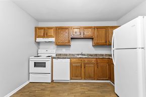 New London apartment for rent - a kitchen with white appliances and wooden cabinets at Eagle Pointe New London, CT, 06320