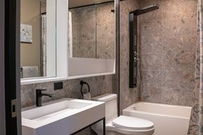 Hartford apartment for rent - A modern bathroom with a sink, toilet, and bathtub.
