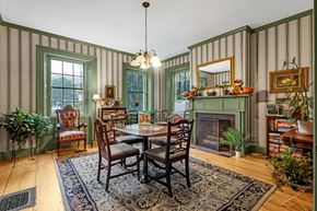 Williamstown apartment for rent - a dining room with a table and chairs and a fireplace