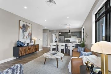 West Hartford apartment for rent - A modern living room with a grey rug and a wooden coffee table.