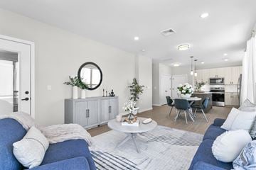Groton apartment for rent - A modern living room with a blue sofa and a white coffee table.