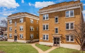 Hartford apartment for rent - A two-story brick building with a green lawn in front.