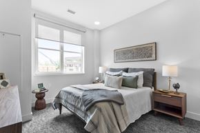 Farmington apartment for rent - A bedroom with a large bed and a window.