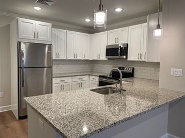 Brookfield apartment for rent - a kitchen with white cabinets and a granite counter top