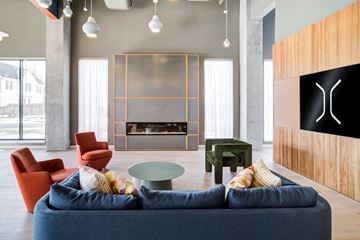 New Haven apartment for rent - A living room with a blue couch and a fireplace.