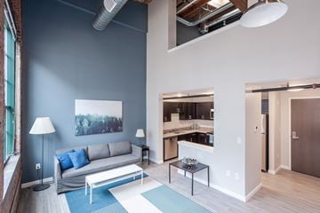 Bridgeport apartment for rent - A living room with a grey couch and a blue rug.