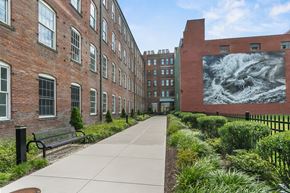 Bridgeport apartment for rent - a sidewalk in front of a building with a large mural on the side at 1188 Lofts, Bridgeport, CT