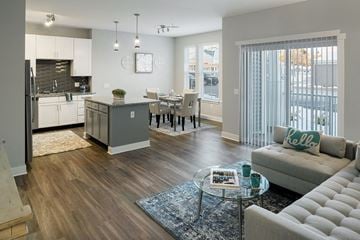 Scarborough apartment for rent - a living room and kitchen with a couch and a table