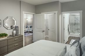 Scarborough apartment for rent - a bedroom with a white bed and a closet at The Beacon at Gateway Apartments, Scarborough, ME, 04074