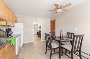 Glastonbury apartment for rent - Dining room and kitchen with a table and chairs at Griswold Gardens in Glastonbury, CT, 06033