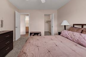 Carol Stream apartment for rent - a bedroom with a bed and a dresser and a closet at St Charles Square Apartments, Carol Stream, IL, 60188
