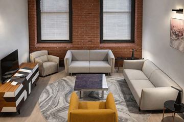 Hartford apartment for rent - A living room with a yellow chair and a grey sofa.
