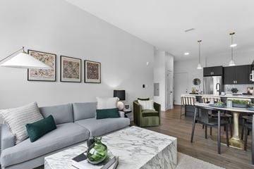 Farmington apartment for rent - A modern living room with a grey sofa and a marble coffee table.