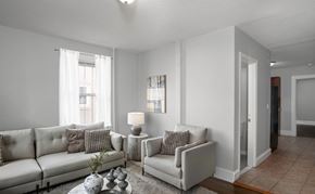 Hartford apartment for rent - A living room with a white couch and a grey armchair.