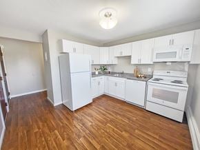 Norwich apartment for rent - A kitchen with white appliances and wooden floors at Rose Hill Estates, Norwich, CT, 06360