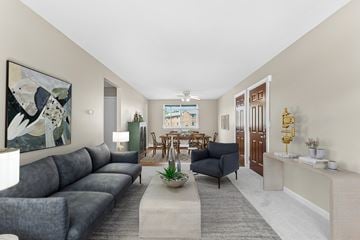 Norwich apartment for rent - A living room with a grey sofa and a painting on the wall.