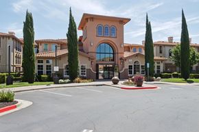 Pittsburg apartment for rent - A large building with a red roof and a large arched window.