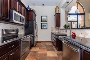 Vacaville apartment for rent - A kitchen with brown cabinets and a tile floor.