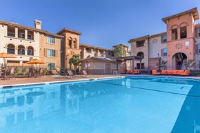 Vacaville apartment for rent - A swimming pool in front of a row of houses.