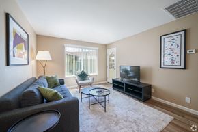 Pittsburg apartment for rent - A living room with a grey couch, a black coffee table, and a flat screen TV.