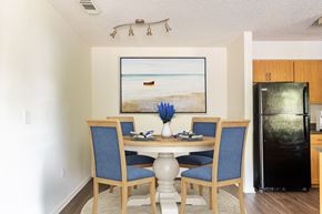 Sarasota apartment for rent - View of Timber Chase Model Dining Nook - staged with table and chairs with track lighting.