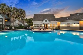Valrico apartment for rent - A swimming pool in front of the Leasing Clubhouse rear exit with modern pool furniture.