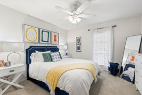 River Ridge apartment for rent - a bedroom with a large bed and a ceiling fan