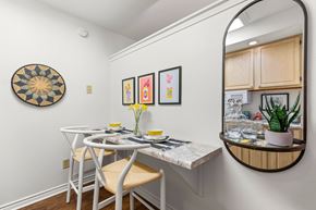 Metairie apartment for rent - A dining area with a white table and chairs.